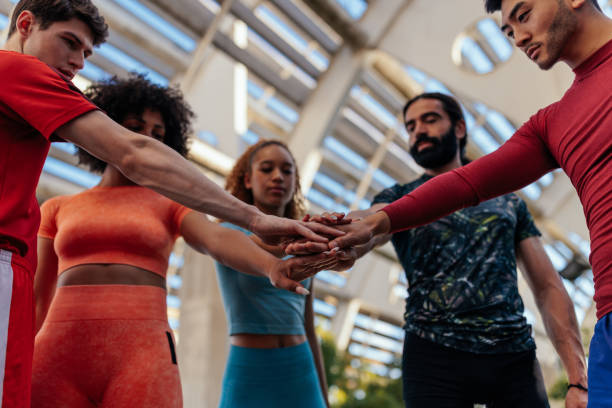 istock Group of athletes in team huddle 1467268819
