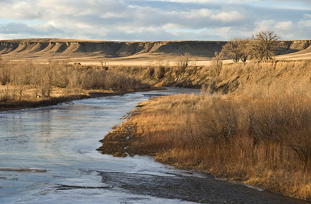 Frozen river and golden buttes