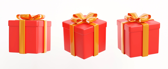 Small red gift box decoratively packed into red paper and tied around with golden ribbon