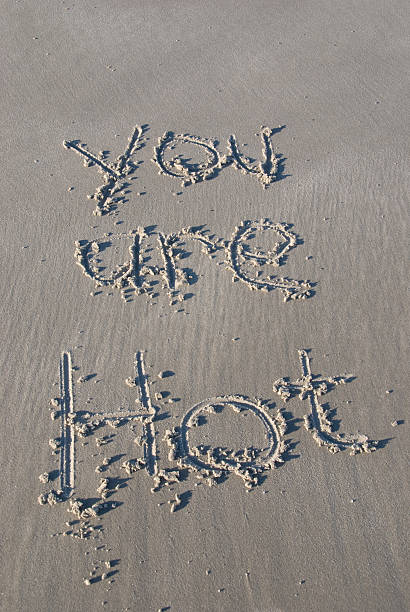 &quot;You are Hot&quot; written in sand stock photo