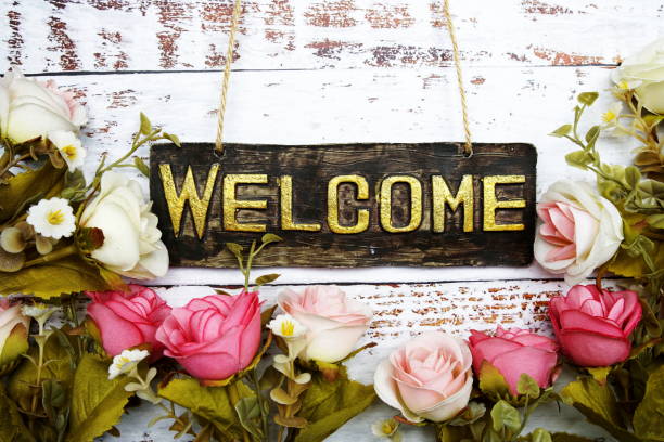 istock Welcome Sign with flowers frame decorate on wooden background 1467270521