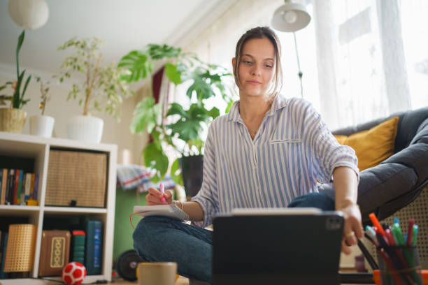 istock Young woman taking notes with pen at home. 1467270721