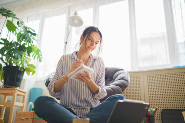 istock Young woman taking notes with pen at home. 1467270799