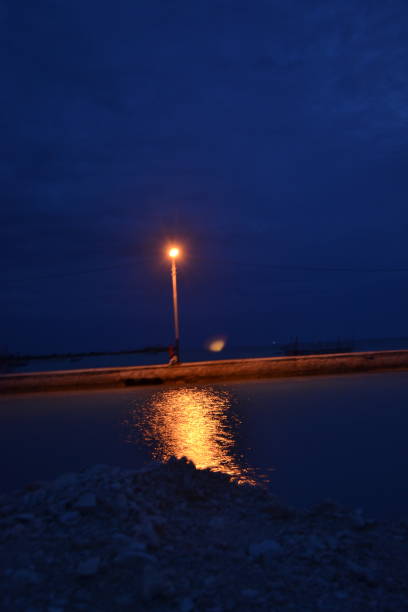 istock warm color lights by the beach at night 1467271407