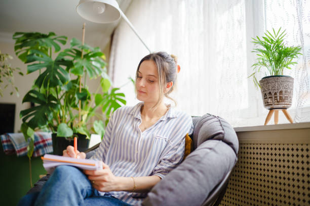 istock Young woman taking notes with pen at home. 1467271569