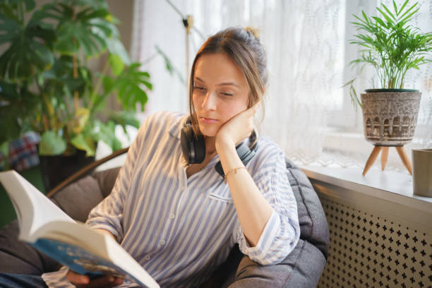istock Young woman reading book on weekend 1467271692