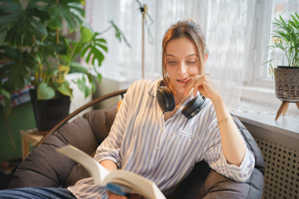 istock Young woman reading book on weekend 1467271708