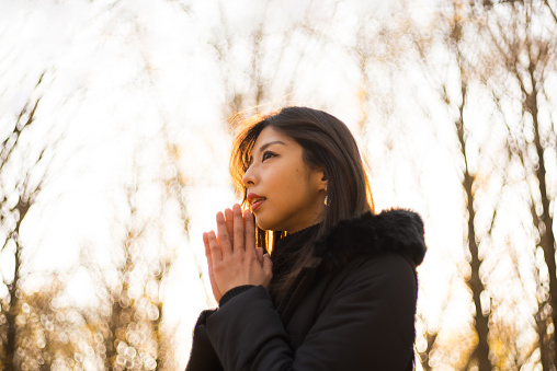 Asian woman praying sincerely with both palms together.
Woman is in nature.
Japanese Models.