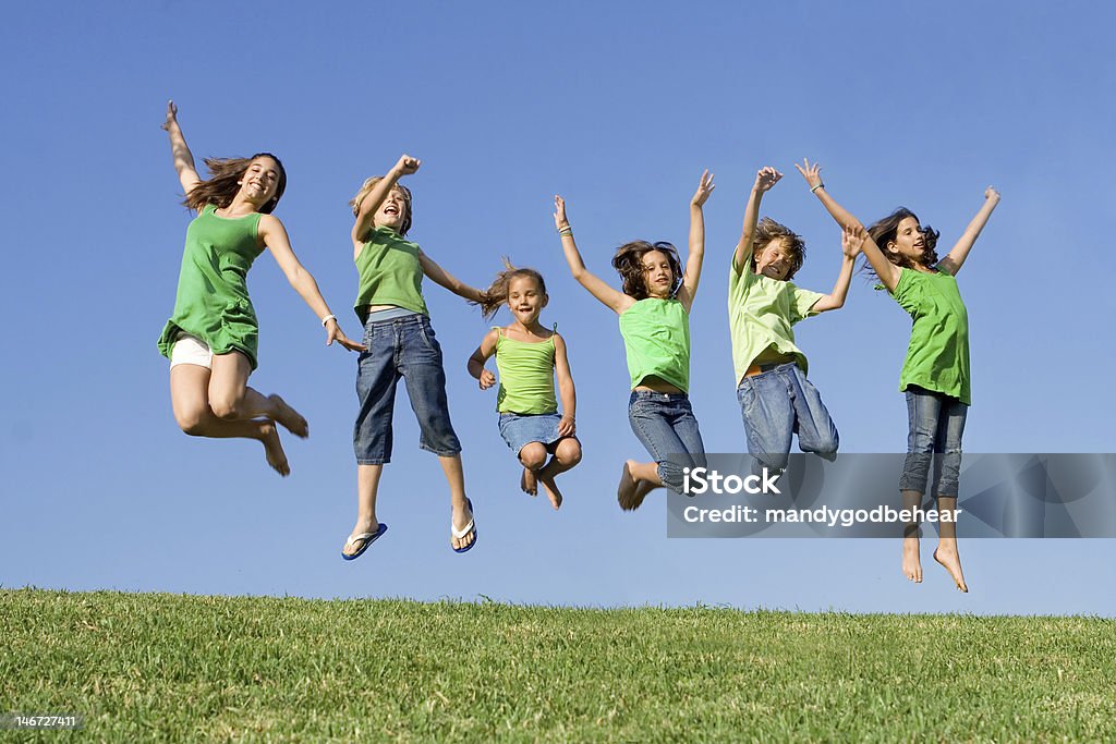 group of hapy smiling kids or children jumping group of hapy smiling kids or children jumping at summer camp Child Stock Photo