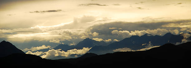 Stormy Mountains these are the Talkeetna Mountains of Alaska, just after a storm and nearing sunset. talkeetna mountains stock pictures, royalty-free photos & images