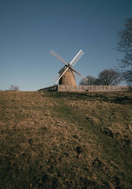 istock Rustic Bembridge windmill situated on top of a hill with lush green grass and a bright blue sky 1467276215
