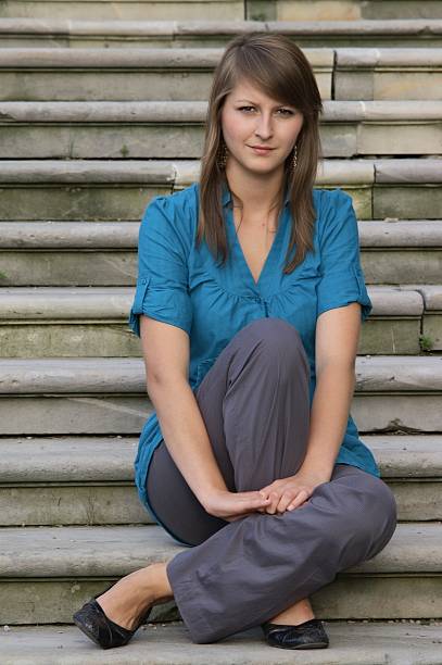 young girl sitting on stairs stock photo
