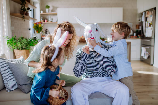 istock Little children having fun with her mother and Easter rabbit, celebrating Easter. 1467277626