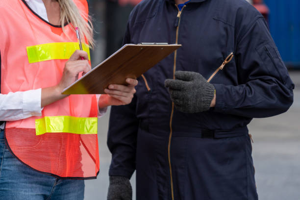 istock Industrial worker works with co-worker at overseas shipping container yard . Logistics supply chain management and international goods export concept . 1467279394
