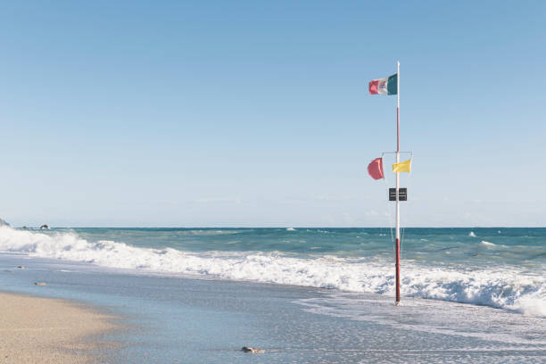 istock Rough sea. Red flag on beach warning about dangerous swim. 1467280422
