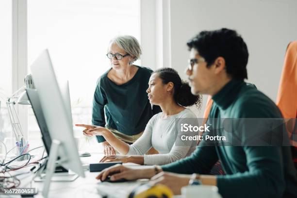 Business People Working Together In An Engineering Office Stock Photo - Download Image Now