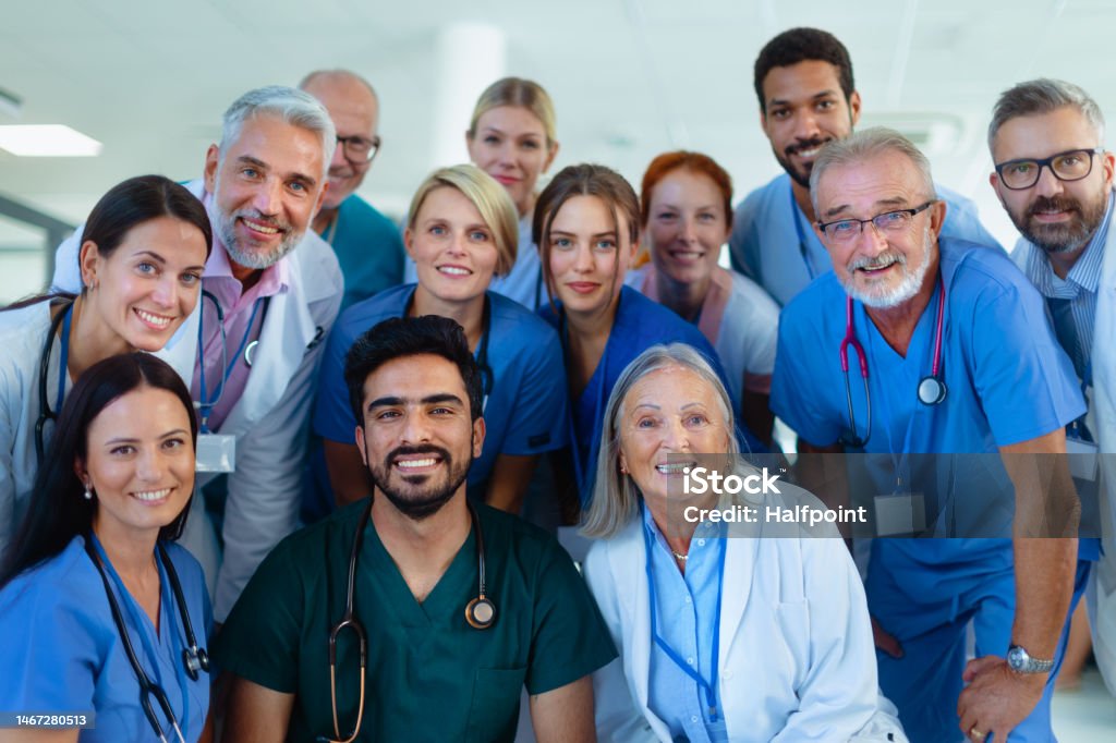 Portrait of happy doctors, nurses and other medical staff in hospital. Portrait of happy doctors, nurses and other medical staff in a hospital. Large Group Of People Stock Photo