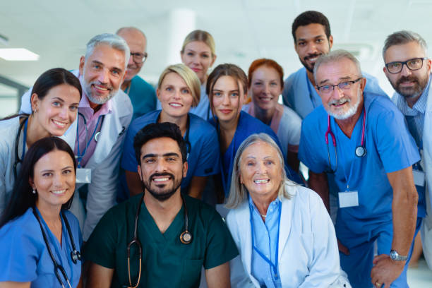 Portrait of happy doctors, nurses and other medical staff in hospital. stock photo