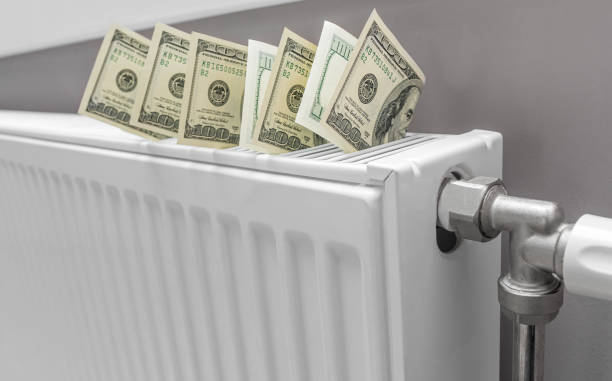 istock Dollars on the heater. Payment for heating. 1467280923