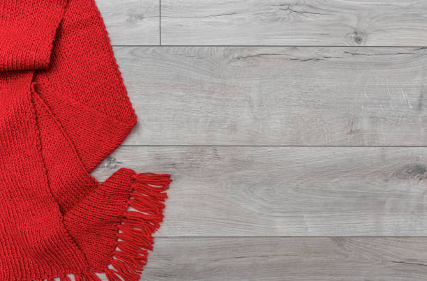 istock Warm knitted scarf on a laminate background. 1467281875