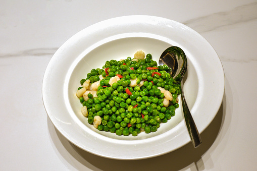 Puree - mashed potatoes with green pea in bowl on wooden table