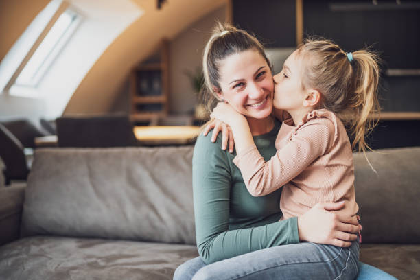 istock Daughter kissing her mother 1467283224