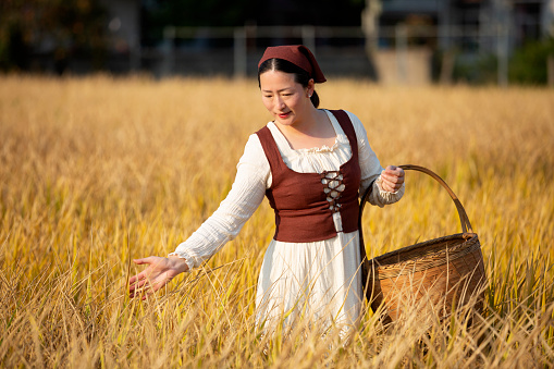 A female farmer in ripe rice field