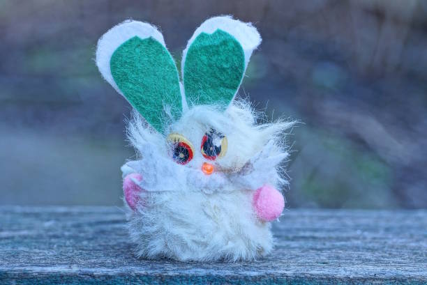 istock one small dirty white fluffy hare toy with green ears 1467287798
