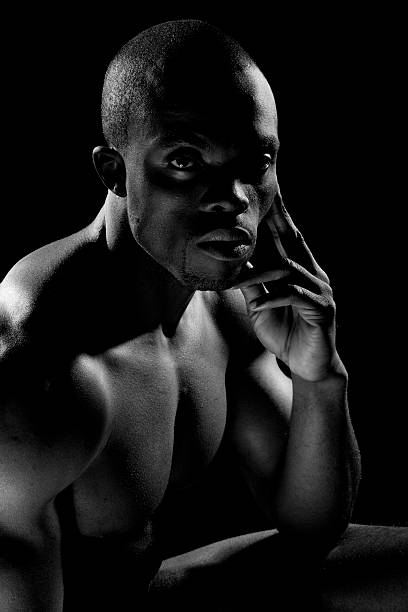 Naked black male looking at camera stock photo