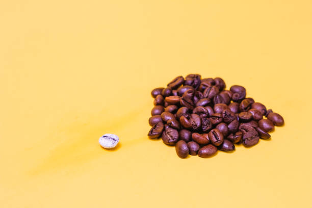 istock coffee beans are black and one bean is white, different from all 1467292480