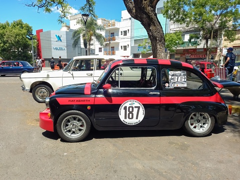 Buenos Aires, Argentina – November 07, 2022: black sport Fiat 600 Abarth sedan unibody for racing. Side view. Expo Warnes 2022 classic car show