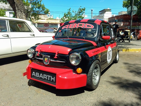 Buenos Aires, Argentina – November 07, 2022: black and red sport Fiat 600 Abarth sedan unibody for racing. Expo Warnes 2022 classic car show