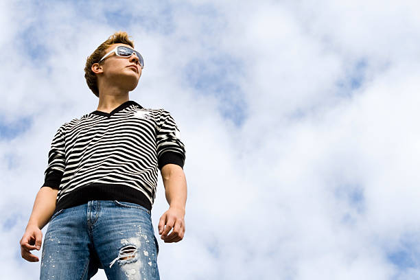 istock Young beautiful man model standing under the cloudy sky. 146729348