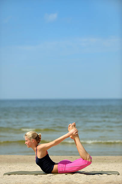 istock Young woman exercising on the beach 146730037