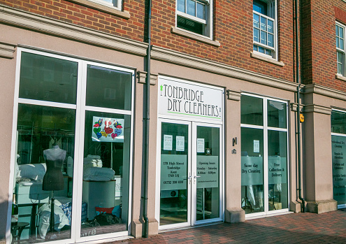 Commercial signs at Tonbridge Dry Cleaners on Tonbridge High Street in Kent, England