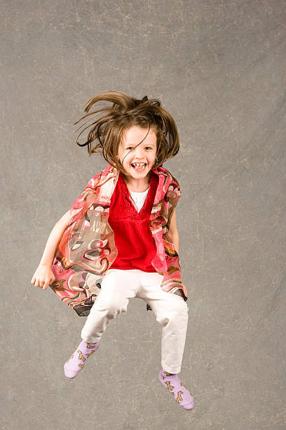 little girl jumping stock photo
