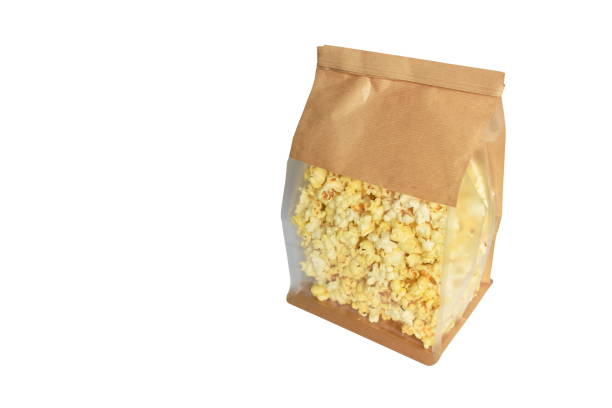 istock salty popcorn in brown paper packaging bag on white background 1467301786
