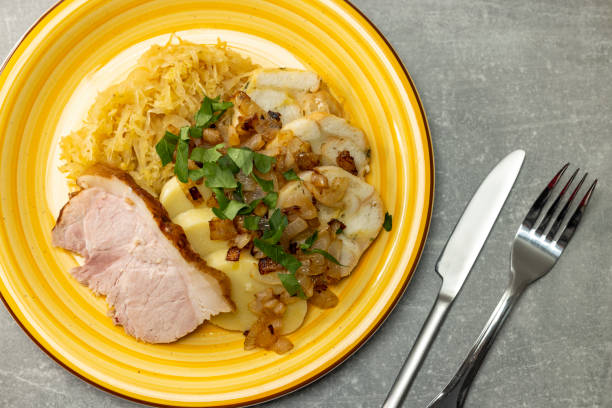 istock pork meat with potato dumplings and pickled cabbage served with roasted onion 1467302704