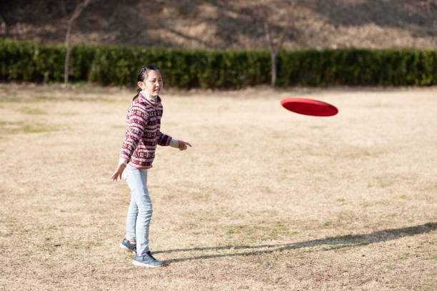 istock Girl playing with flying disc in winter park 1467303408