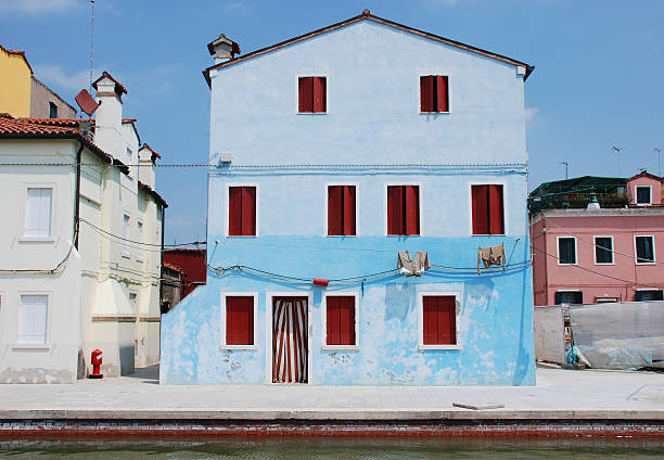 Blue House with Red Shutters Burano Italy stock photo