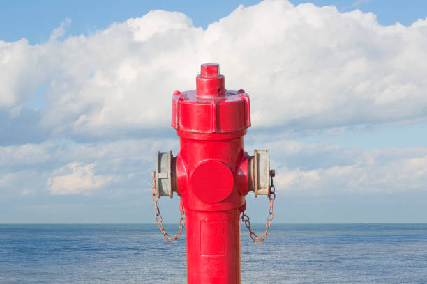 istock An improbable hydrant at the seaside - Plenty of water concept image with red hydrant against ocean 1467306138