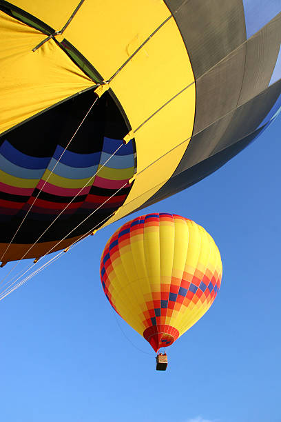 Two hot air balloons in flight stock photo