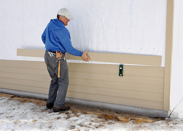 Carpenter installing siding Carpenter using gauge to install fibrous cement siding siding building feature photos stock pictures, royalty-free photos & images