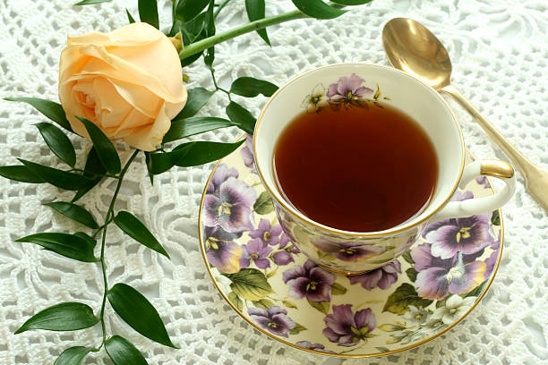 istock Cup of tea and rose on knitted table cover 146731807