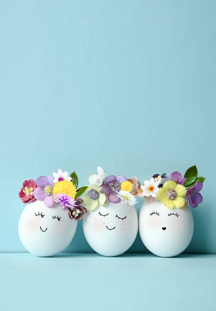istock Funny Easter Eggs, hand drawn faces. Easter holiday concept with cute handmade eggs in floral wreath crowns. 1467318887