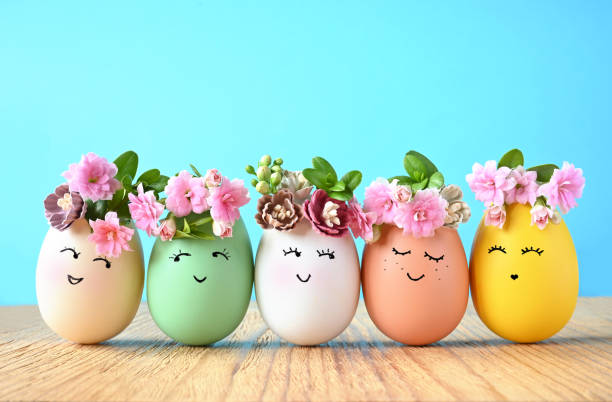 istock Funny Easter Eggs, hand drawn faces. Easter holiday concept with cute handmade eggs in floral wreath crowns. 1467318888