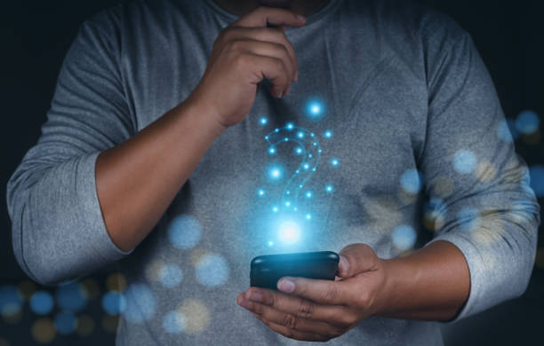 istock Business man hands with mobile phone doing decision with question marks sign. Faq and choice concept. Business decision faq. 1467319025