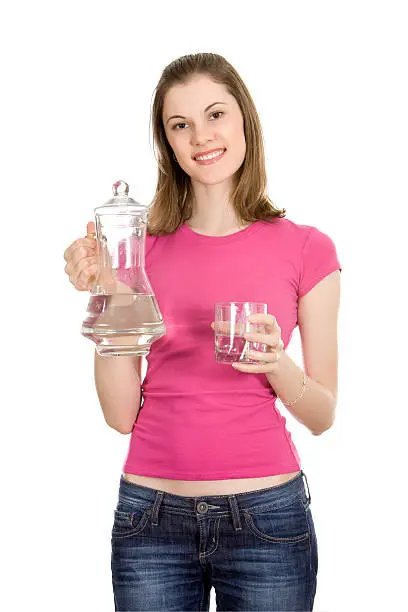 Beautiful girl holding a water-bottle and a glass of water; isolated on white background.
