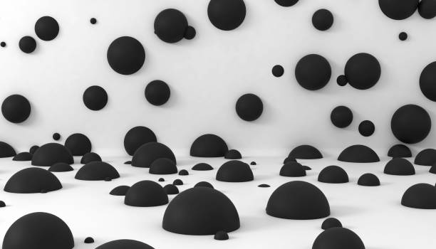 Abstract black spheres on white backdrop wall stock photo