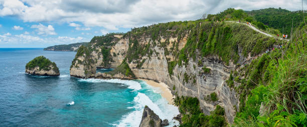 istock Atuh Beach is a Rustic, isolated cove beneath a sheer cliff face, with a sandy beach offshore rock formations. 1467319935